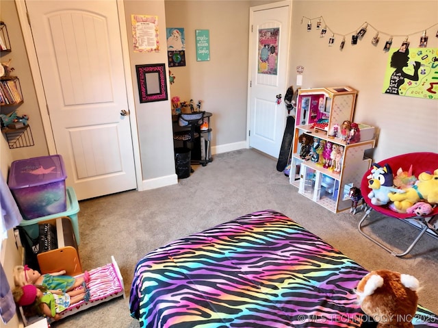 carpeted bedroom featuring baseboards