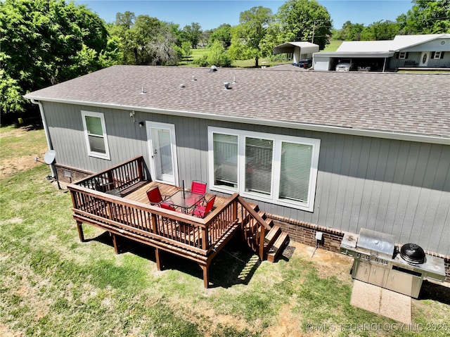 back of house featuring a yard, roof with shingles, and a wooden deck