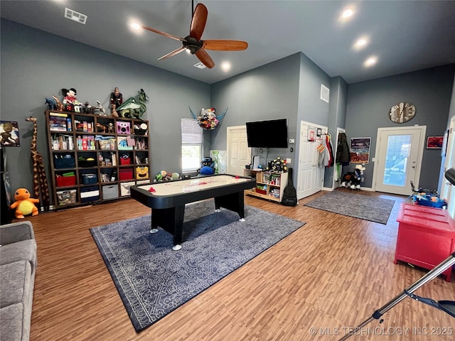 playroom with a wealth of natural light, visible vents, and wood finished floors