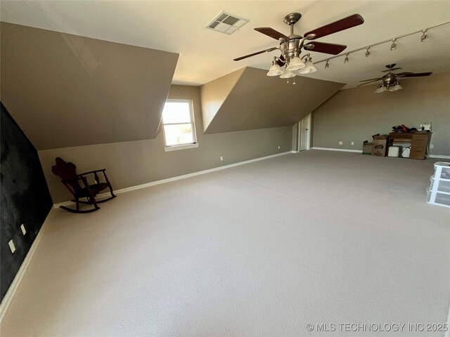 additional living space with baseboards, visible vents, lofted ceiling, ceiling fan, and carpet floors