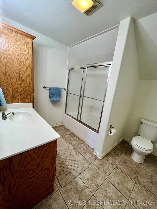 full bath featuring toilet, shower / bath combination with glass door, visible vents, vanity, and tile patterned floors