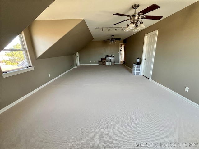 bonus room with carpet, baseboards, vaulted ceiling, and a ceiling fan