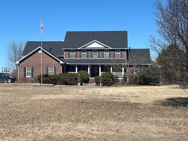 view of front of property with brick siding and a porch