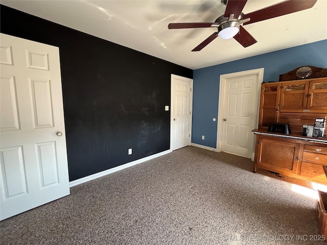 unfurnished bedroom featuring carpet floors, ceiling fan, and baseboards