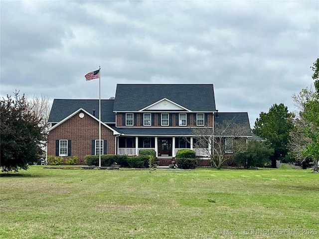 840 E 53rd St S, Muskogee, OK 74403 - view of front of house featuring covered porch, a front lawn, and brick siding