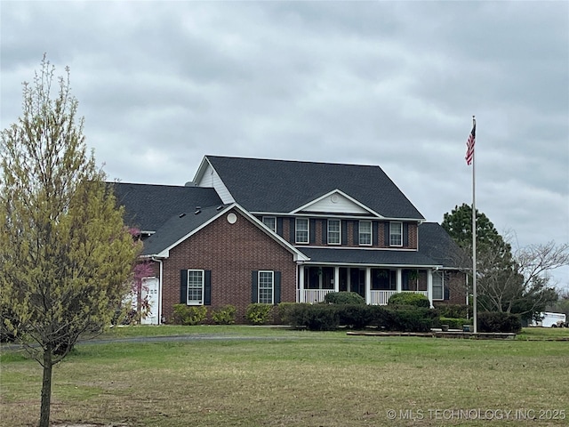 840 E 53rd St S, Muskogee, OK 74403 - view of front facade with brick siding, a front lawn, roof with shingles, and covered porch
