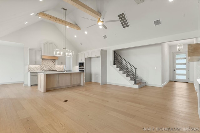 2719 E 135th Dr S, Bixby, OK 74008 - kitchen featuring high vaulted ceiling, open floor plan, visible vents, and ceiling fan with notable chandelier