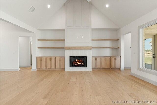 2719 E 135th Dr S, Bixby, OK 74008 - unfurnished living room featuring high vaulted ceiling, light wood-style floors, a fireplace, baseboards, and visible vents