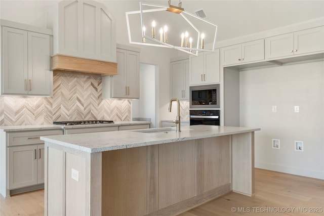 2719 E 135th Dr S, Bixby, OK 74008 - kitchen featuring a sink, built in microwave, visible vents, gas stovetop, and black oven