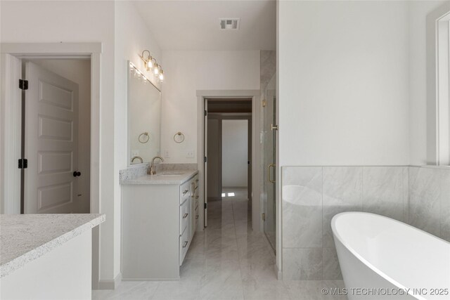 2719 E 135th Dr S, Bixby, OK 74008 - full bathroom featuring a stall shower, a freestanding tub, vanity, marble finish floor, and visible vents