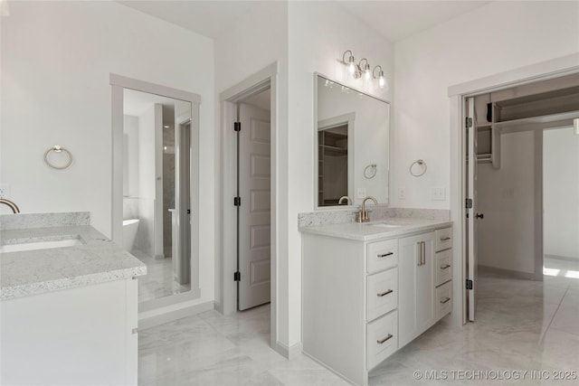 2719 E 135th Dr S, Bixby, OK 74008 - full bathroom featuring two vanities, baseboards, marble finish floor, and a sink