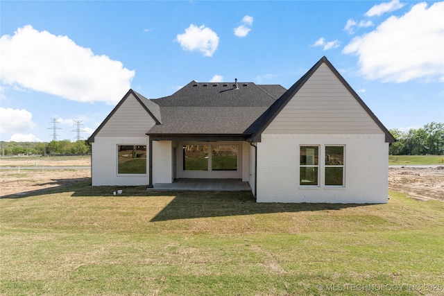 2719 E 135th Dr S, Bixby, OK 74008 - rear view of house with a patio area, a lawn, brick siding, and roof with shingles