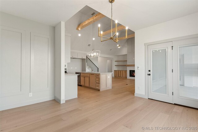 2719 E 135th Dr S, Bixby, OK 74008 - kitchen with open floor plan, light wood finished floors, light countertops, a chandelier, and high vaulted ceiling