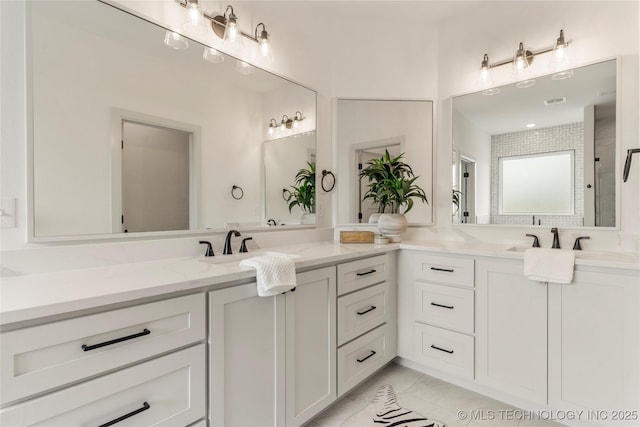 bathroom featuring a shower and vanity