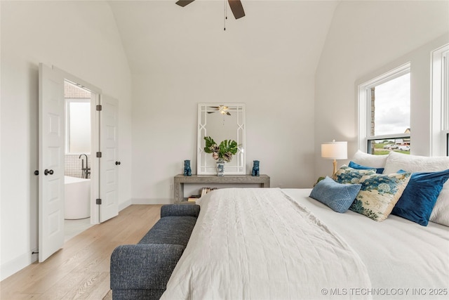 bedroom with a ceiling fan, high vaulted ceiling, baseboards, and light wood-style floors