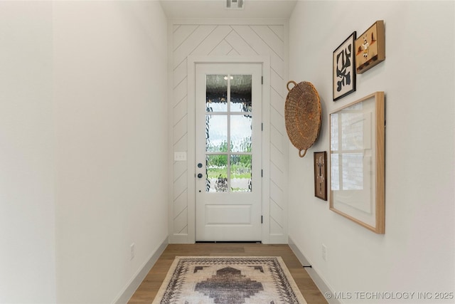 entryway with light wood-style floors, visible vents, and baseboards