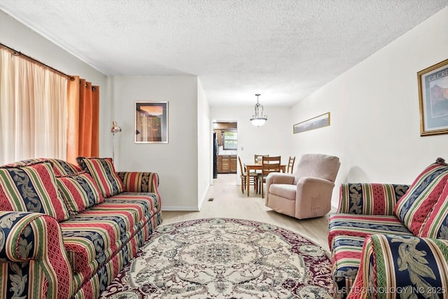 living room featuring a textured ceiling and baseboards