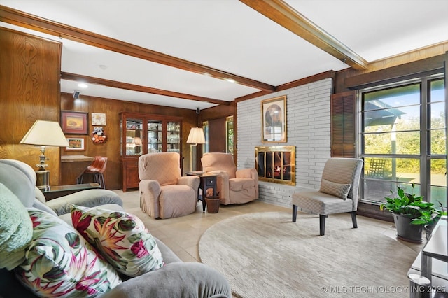 tiled living area with a brick fireplace, wood walls, and beam ceiling