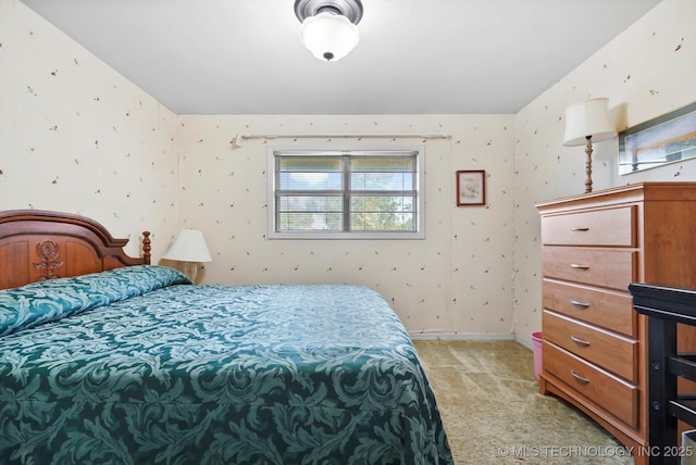 bedroom with light carpet, wallpapered walls, and baseboards