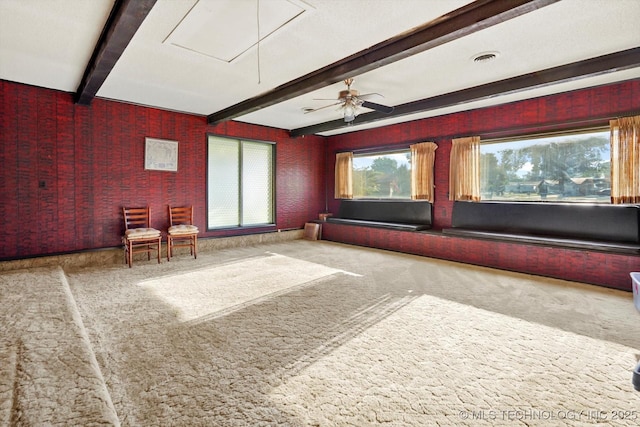 carpeted cinema with visible vents and beam ceiling