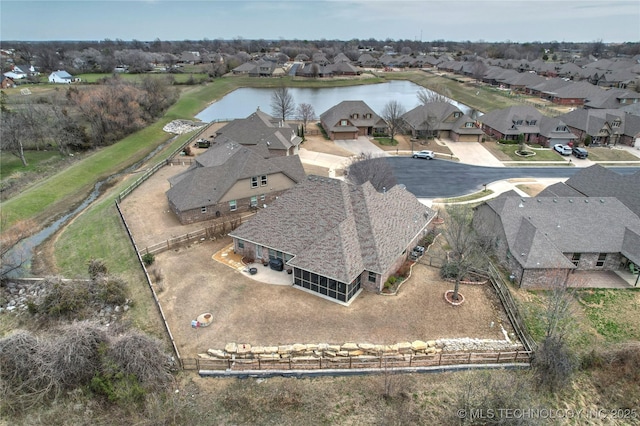 birds eye view of property featuring a residential view and a water view