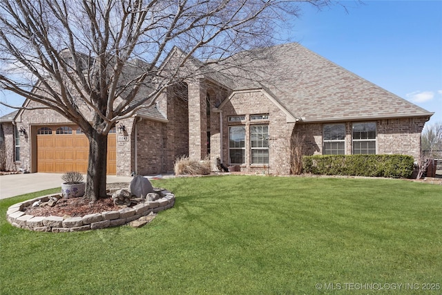 view of front of property featuring driveway, brick siding, a front lawn, and a shingled roof