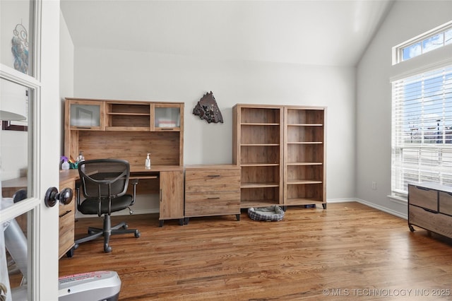 office space featuring wood finished floors and vaulted ceiling