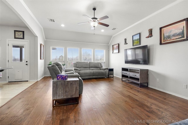 living area featuring visible vents, ornamental molding, and hardwood / wood-style floors