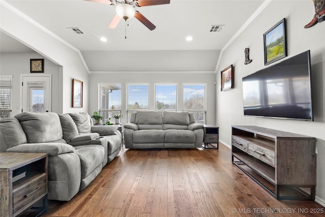 living room with visible vents, lofted ceiling, crown molding, and hardwood / wood-style flooring