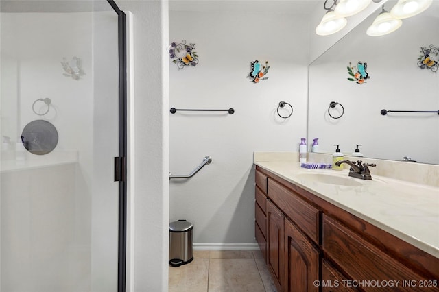 full bathroom featuring tile patterned flooring, a shower stall, vanity, and baseboards