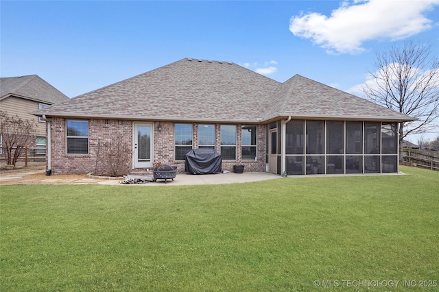 back of property with a patio area, fence, a yard, and a sunroom