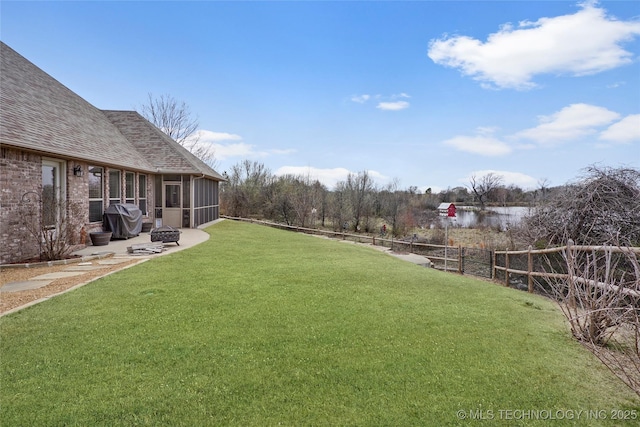 view of yard featuring fence and a sunroom