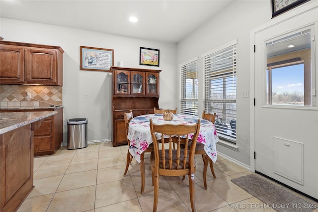 dining room featuring light tile patterned flooring, recessed lighting, and baseboards