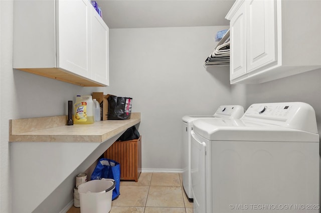 laundry room with cabinet space, light tile patterned floors, independent washer and dryer, and baseboards