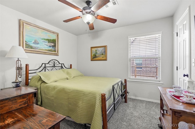 carpeted bedroom featuring visible vents, baseboards, and a ceiling fan