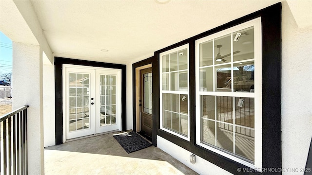 entrance to property with stucco siding and french doors