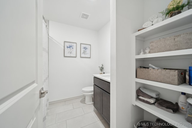 bathroom with tile patterned flooring, visible vents, vanity, and toilet