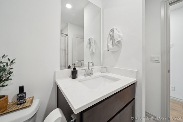 full bathroom with toilet and vanity