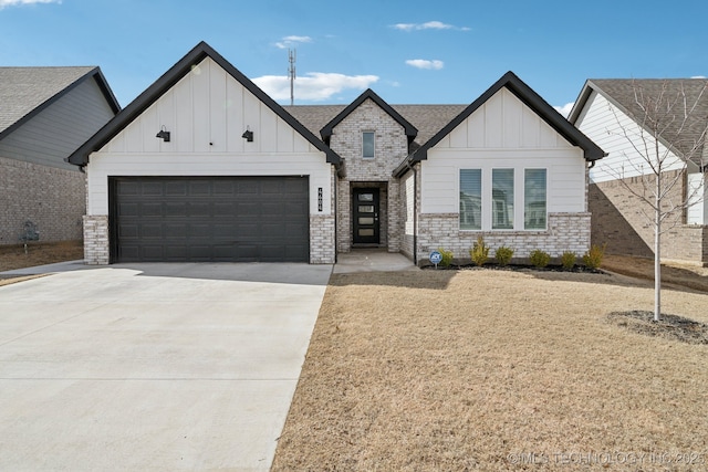 modern farmhouse style home with a garage, driveway, board and batten siding, and roof with shingles