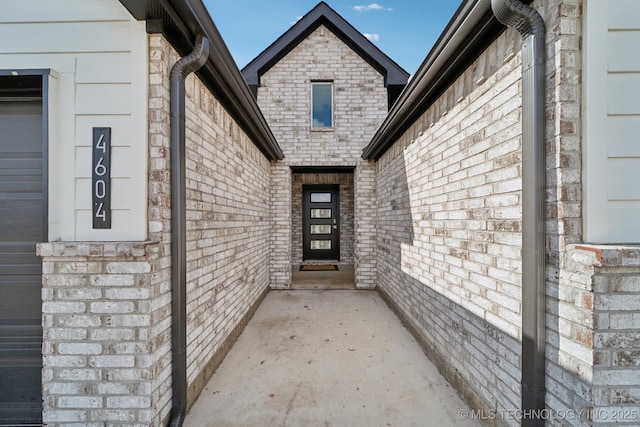 property entrance featuring brick siding