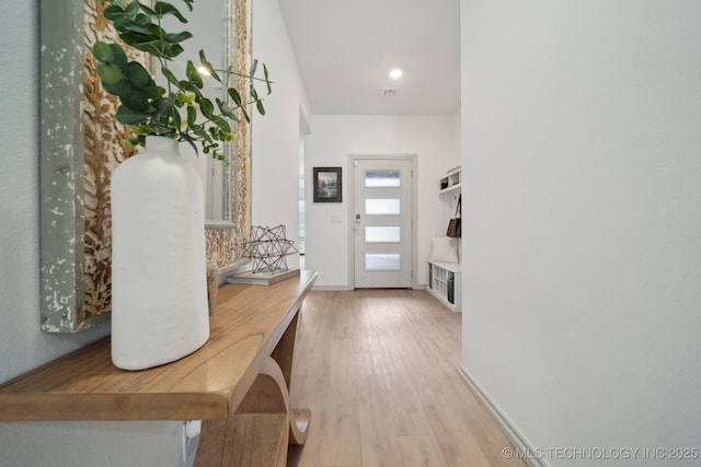 mudroom with visible vents, baseboards, and wood finished floors