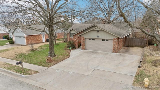 ranch-style home featuring a front lawn, a garage, brick siding, and driveway