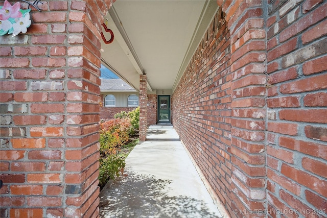 view of exterior entry with brick siding