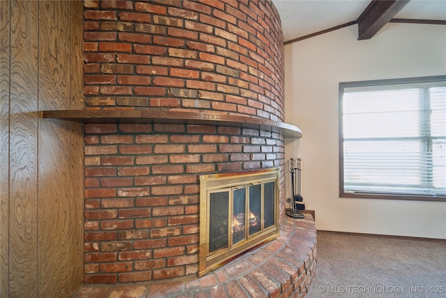 room details with beam ceiling, carpet, a fireplace, crown molding, and baseboards