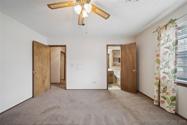 unfurnished bedroom with connected bathroom, a ceiling fan, carpet floors, and a textured ceiling