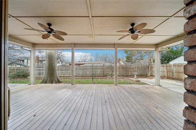 deck with a fenced backyard and a ceiling fan