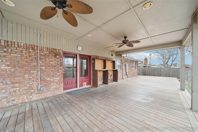 wooden deck featuring a ceiling fan and fence