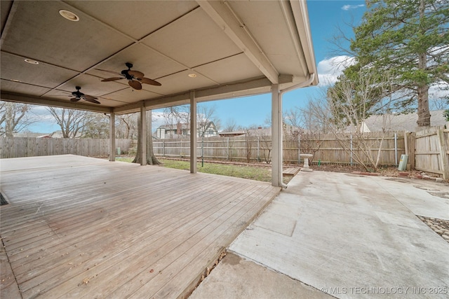 wooden terrace with a fenced backyard, a patio, and ceiling fan