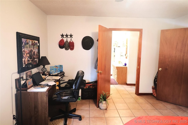 office area with light tile patterned flooring and baseboards