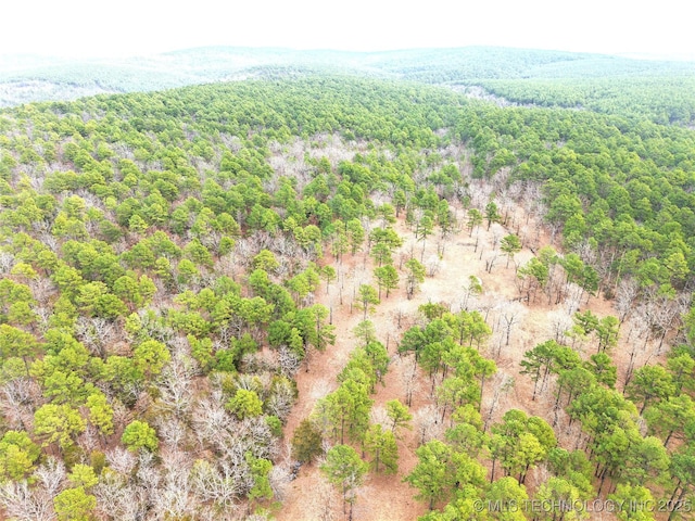 birds eye view of property featuring a view of trees